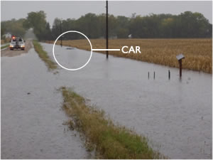 green photo of car in flood